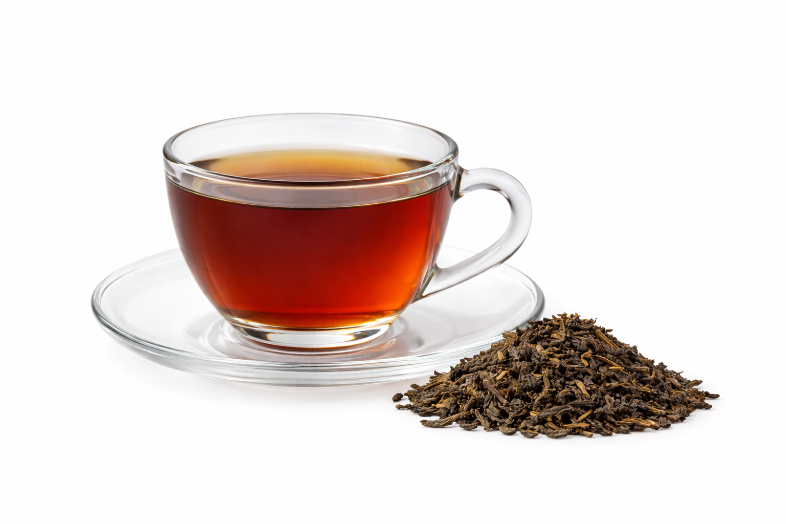 Brewed black tea in glass cup with Camellia sinensis leaves