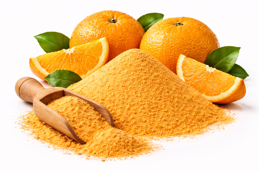 Orange powder made from Citrus sinensis fruit with fresh oranges on white background